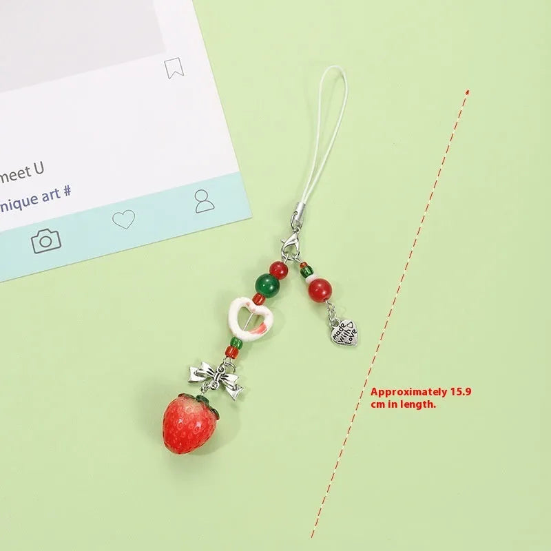 Mobile phone charm keychain with fruit designs including apple and strawberry patterns