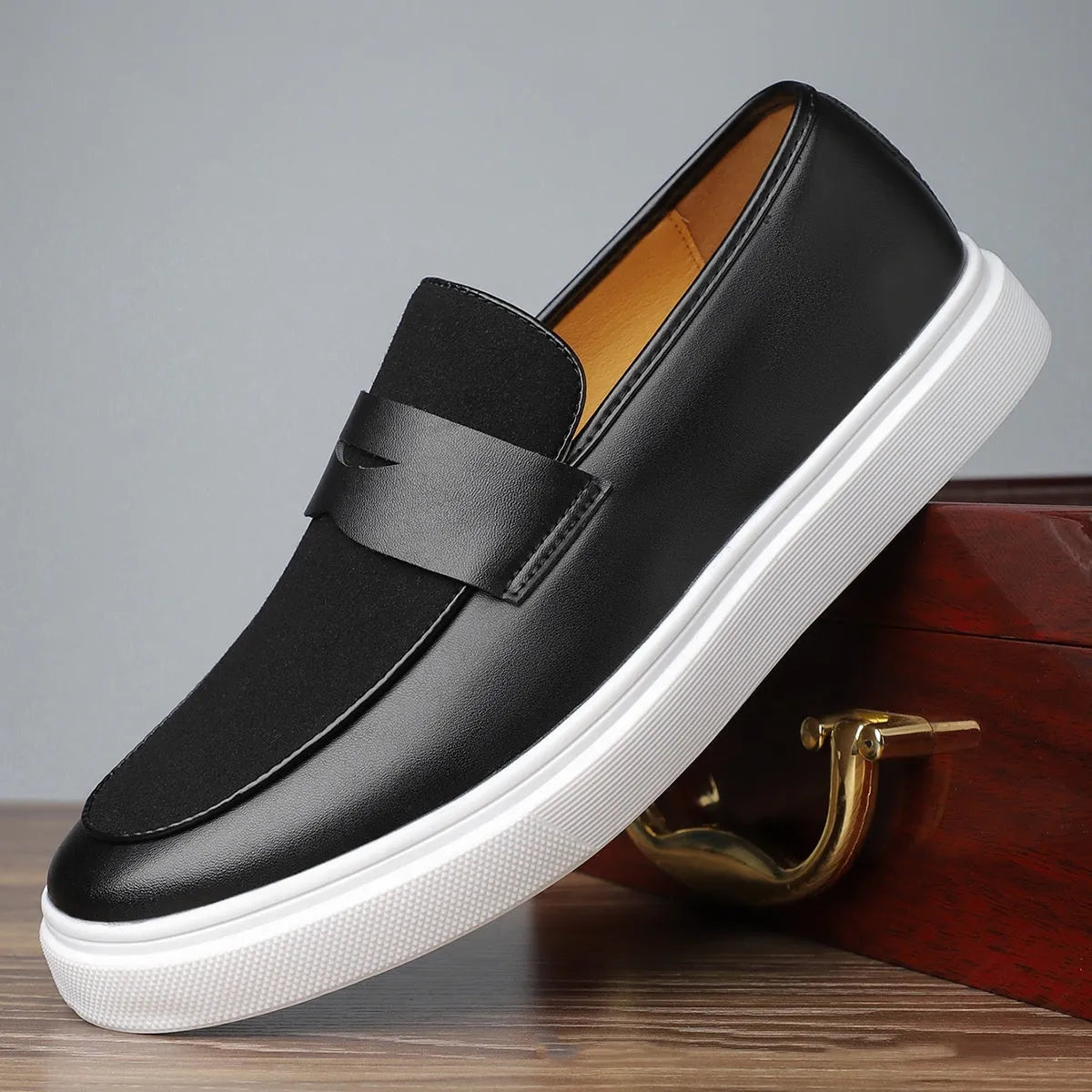 Black men's casual slip-on shoes with tassel detail and round toe on a gommino rubber sole