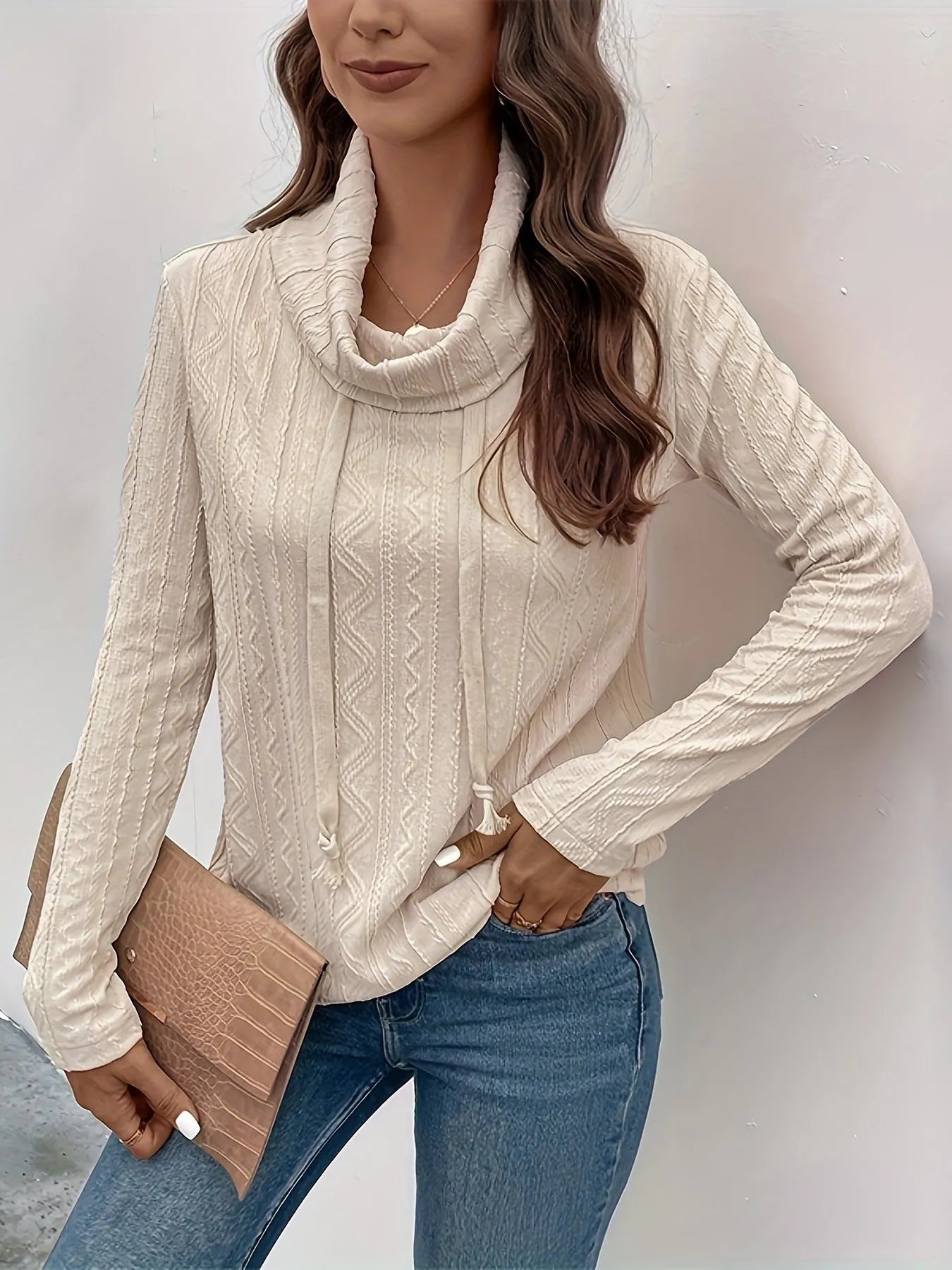 Apricot hooded pullover sweater with long sleeves on hanger