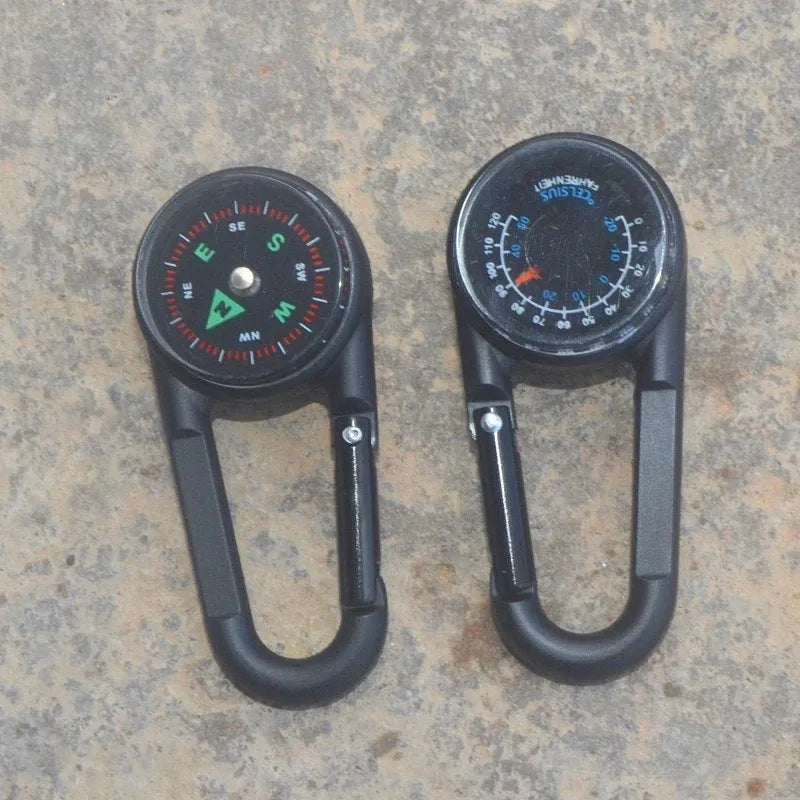 Black zinc alloy camping carabiner with built-in compass and thermometer, showing double-sided button and 65mm size.