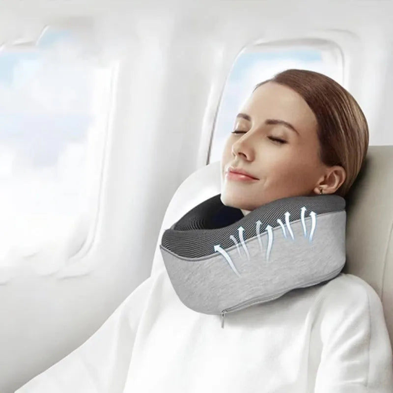 Navy blue U-shaped travel neck pillow with memory foam, shown rolled up next to its carry bag.