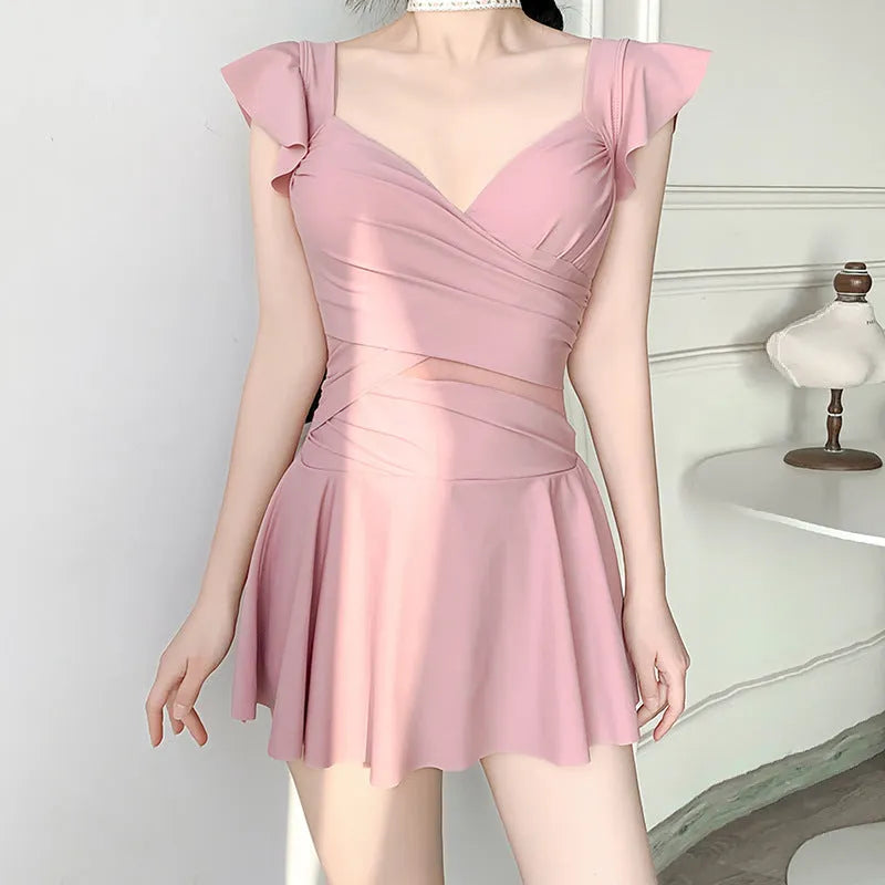 A solid colour one-piece swimsuit for women in black, green, or pink, made from Milk Silk fabric.