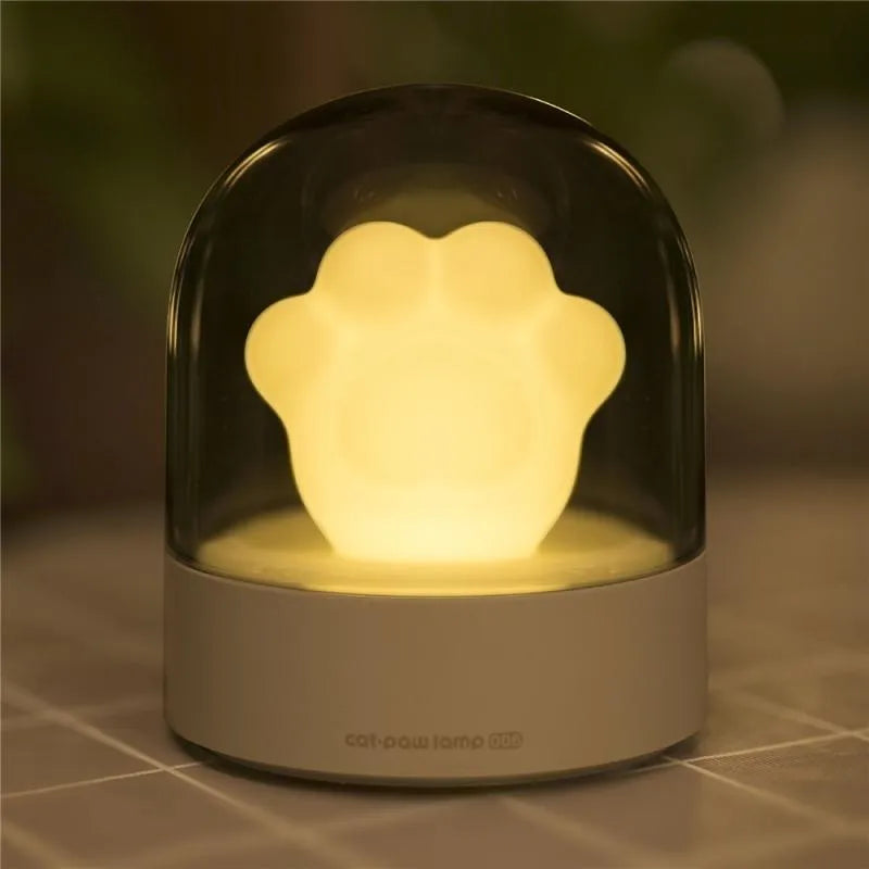 Pink cat paw shaped night light with USB charging cable and music box function