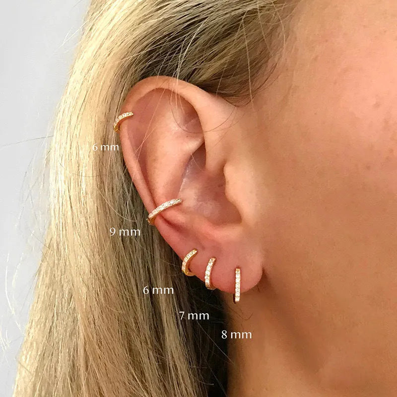 Geometric circle shape zircon perforated stud earrings in gold, rose gold, and silver colour on a white background.
