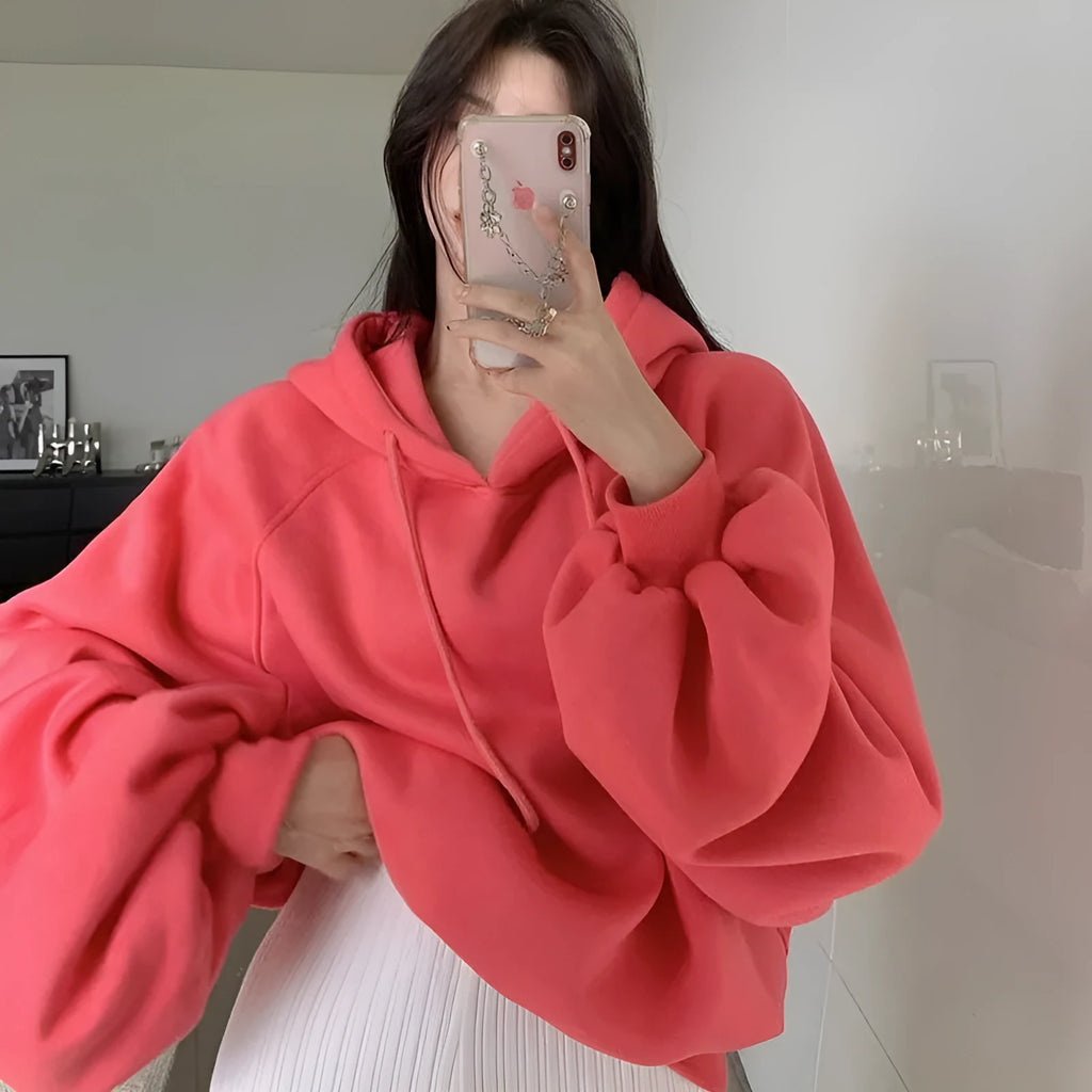 Watermelon red mulberry silk sleeveless hooded sweater for women on a hanger.