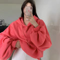 Watermelon red mulberry silk sleeveless hooded sweater for women on a hanger.