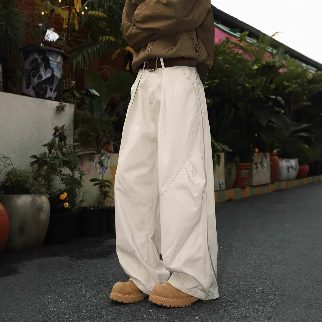 Men's loose straight-leg pleated trousers in apricot stripes on a mid-waist fit model.