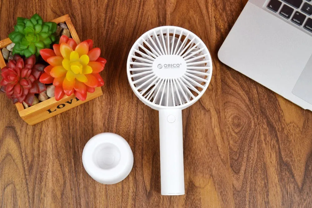 White ORICO FH1 portable USB rechargeable desk and handheld fan on a table