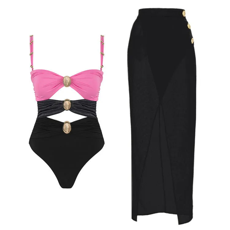 Women's black one-piece swimsuit with a detachable skirt and a gold button detail on the front