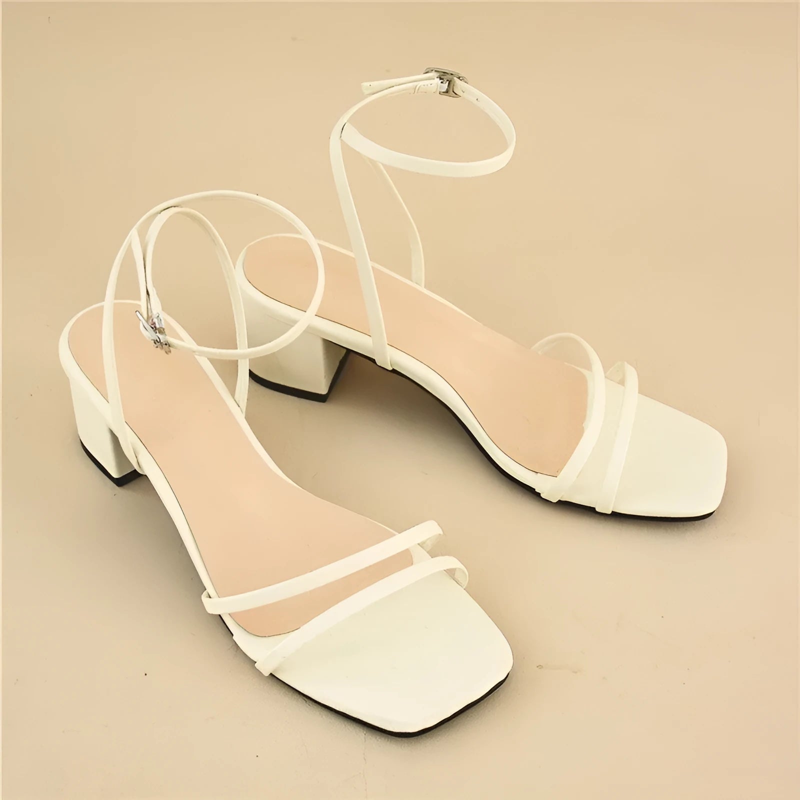 Beige women's square-toe sandals with a stiletto chunky heel and ankle buckle.
