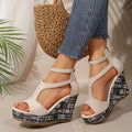 Women's thick-soled slope sandals with ankle-strap buckle in cloth upper and hemp-soled rubber construction