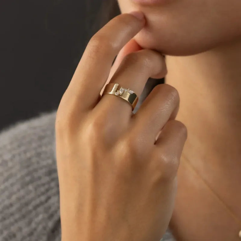 Women's gold electroplated zircon ring on finger showing brilliant stones and metallic finish