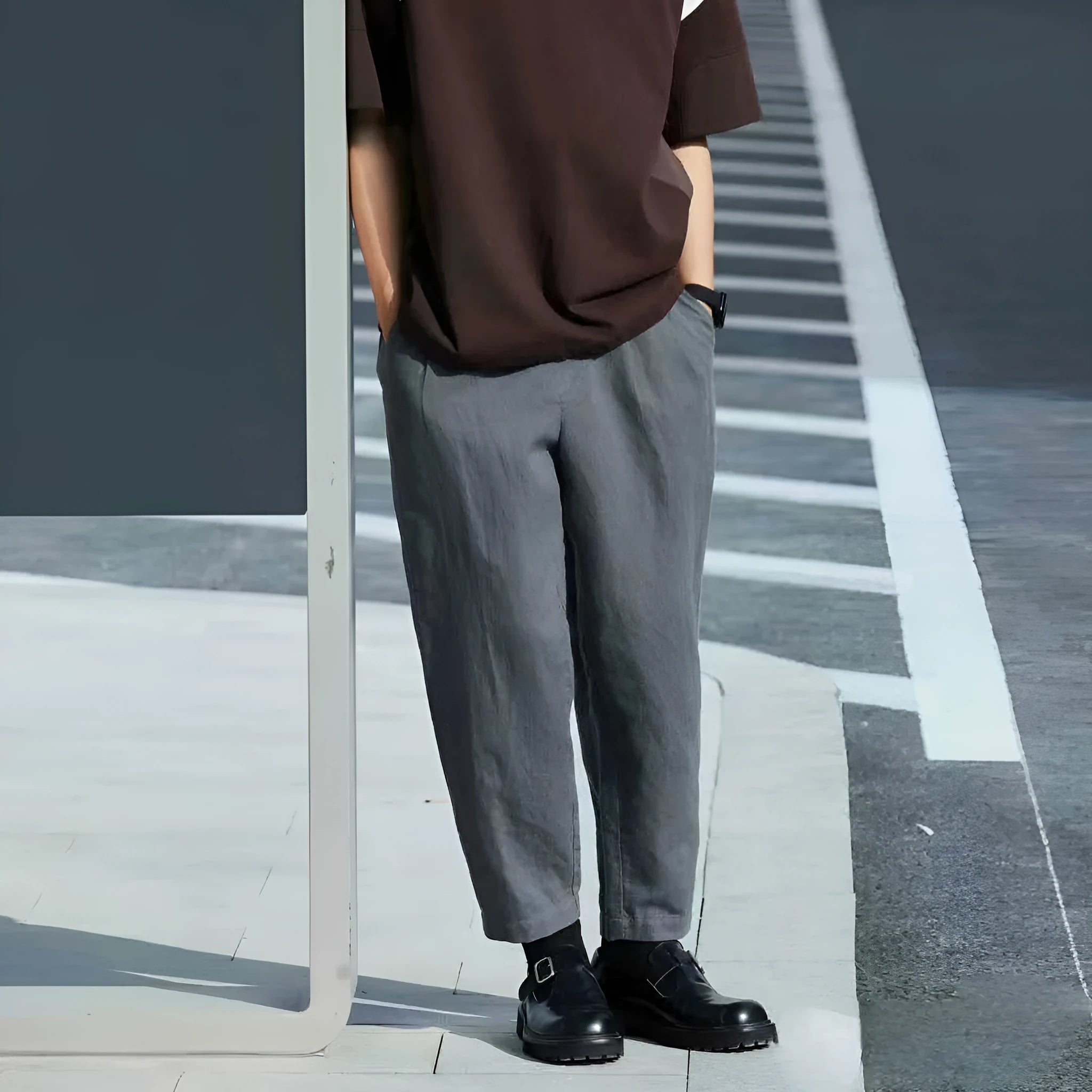 Man wearing beige loose straight-leg casual pants with a drawstring waistband.