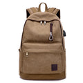 Canvas backpack in grey colour showing external USB port and multiple compartments.