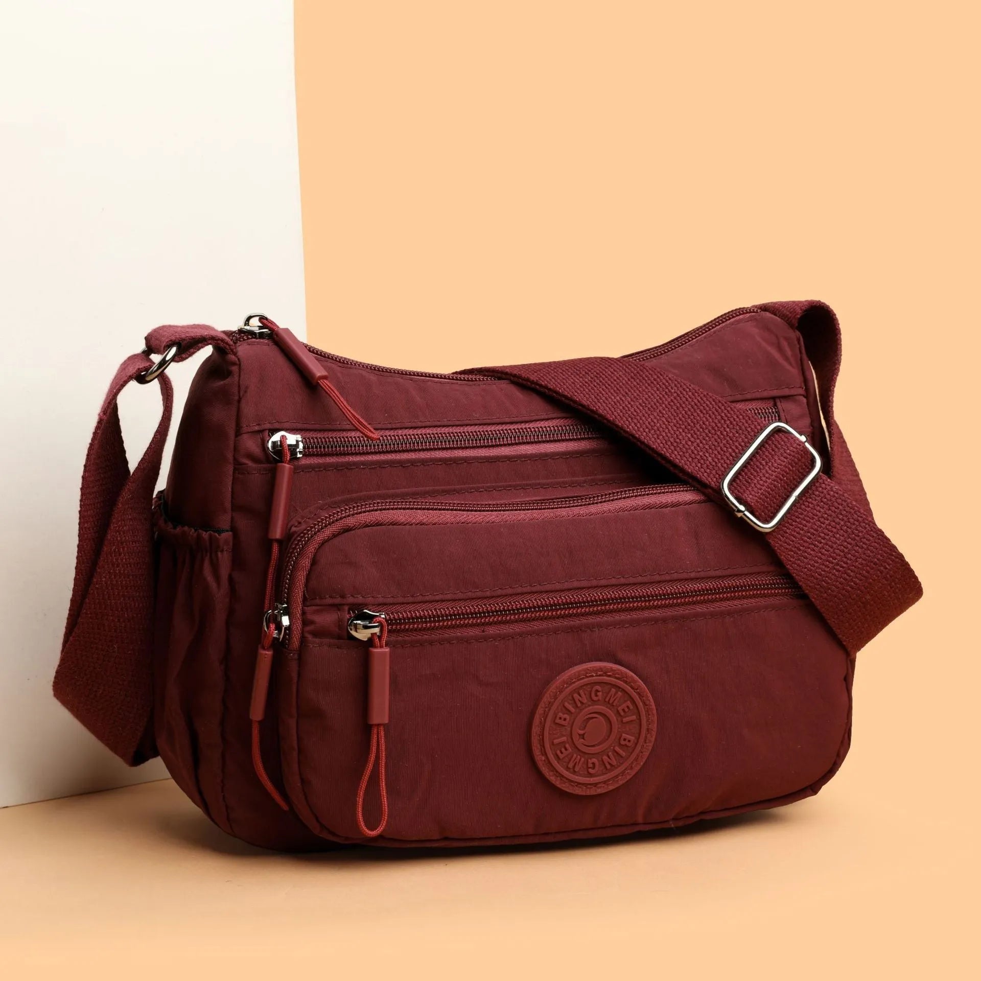 Water-repellent nylon crossbody cloth bag in black, grey or red with internal zipper compartments