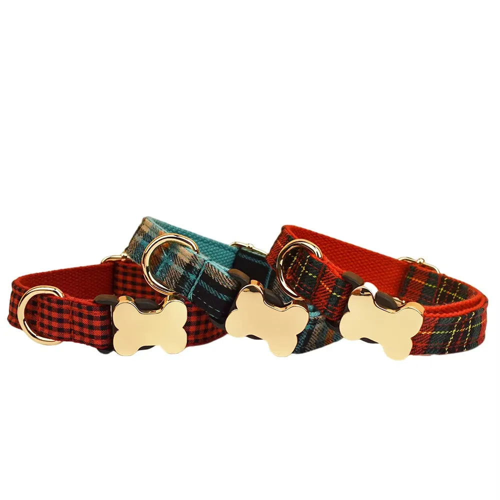 Flat nylon dog collar with a printed grid pattern and a silver bone-shaped metal buckle on a blue background.