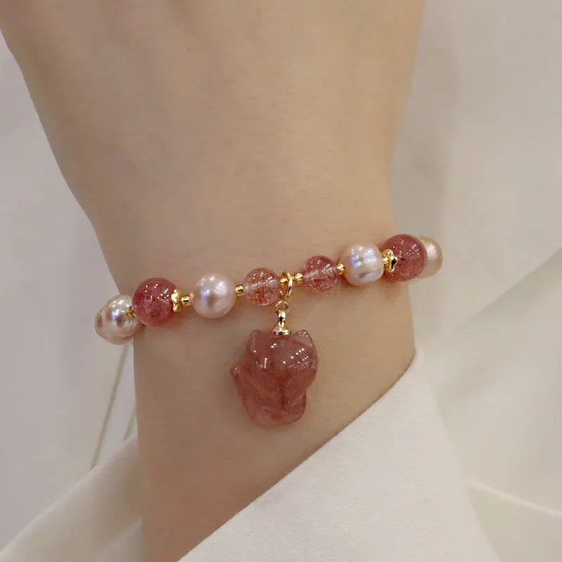 Light pink women's freshwater pearl bracelet with strawberry quartz stones and fox charm