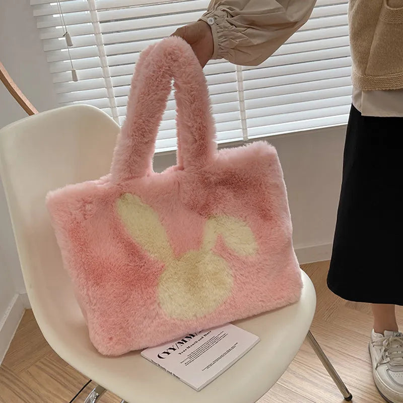 Plush shoulder bag with cartoon rabbit ears design in solid colour