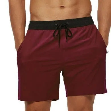 Men's blue running shorts with drawstring waist, stitching detail, and a headband pocket.
