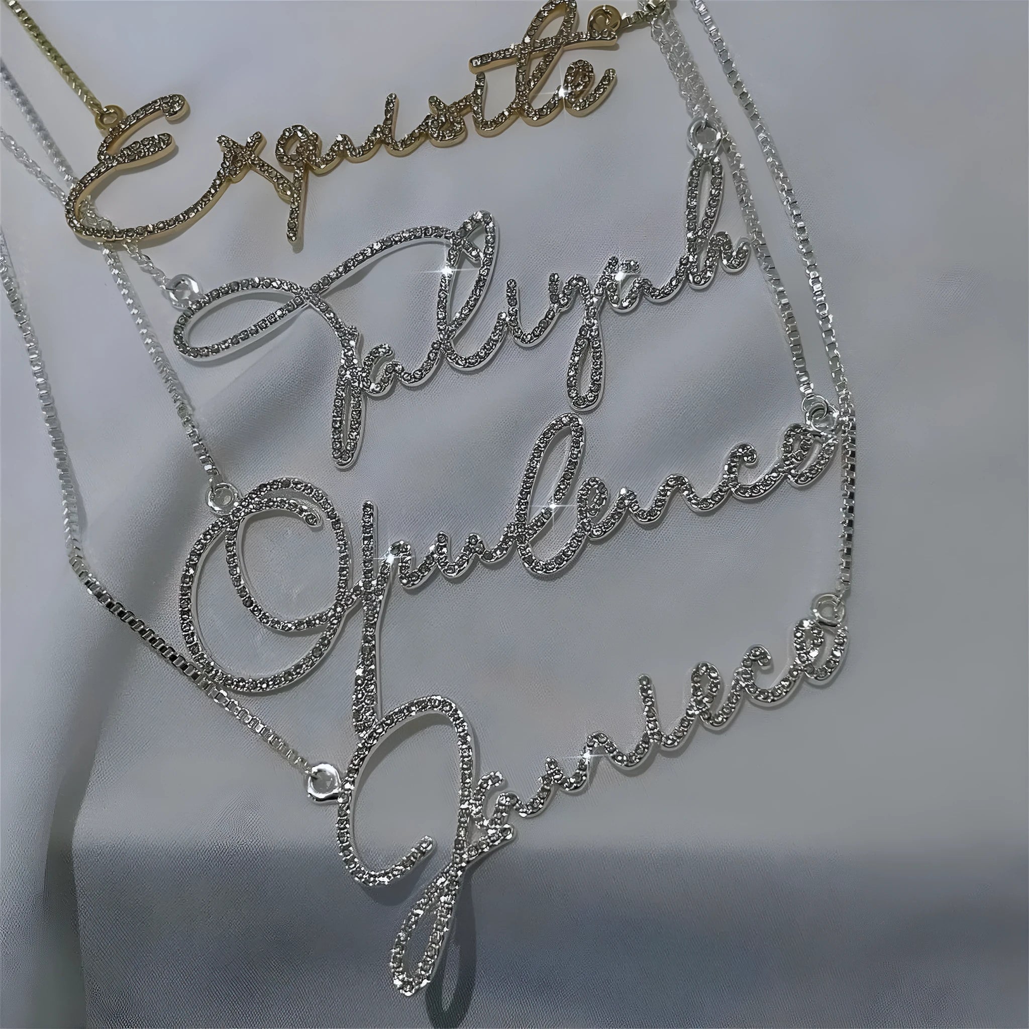 Stainless steel name necklace with diamond-studded letters on an adjustable chain in silver, gold or rose gold.