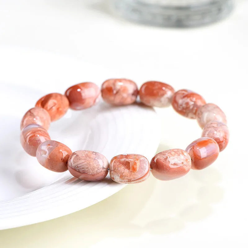 Natural cherry agate barrel bead bracelet with Ruyi charm showing 10x14mm beads
