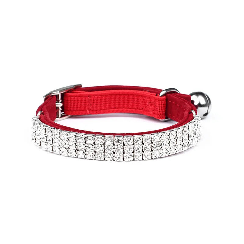 A red velvet cat collar decorated with rhinestones, showing its adjustable length design.