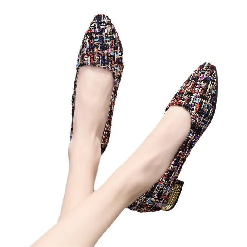 Women's black and white canvas flats with flower pattern, pointed toe, and low-cut design