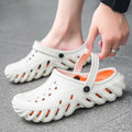 Men's beige EVA slipper sandals with a perforated hollow-out design and a round toe.