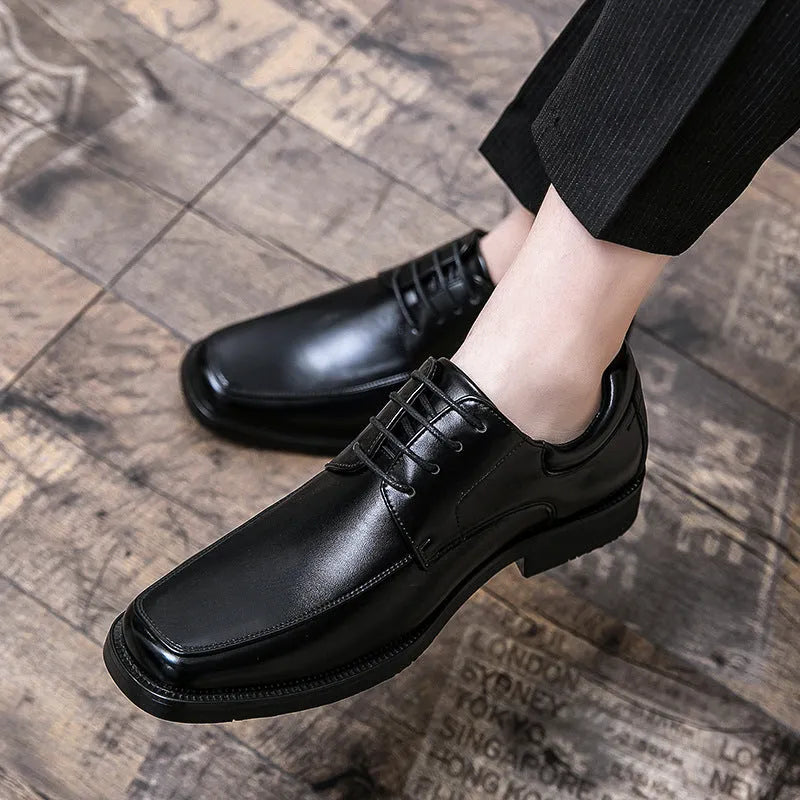 Men's black square toe business casual leather shoes with rubber sole on wooden background
