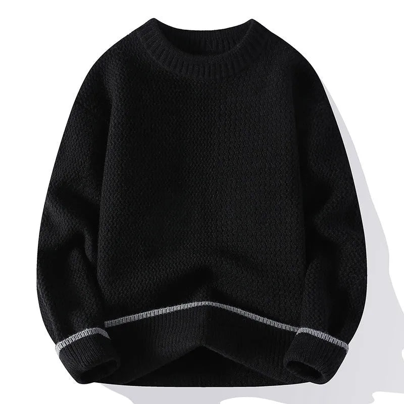 Man wearing a grey loose fit round neck long sleeve pullover sweater