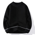 Man wearing a grey loose fit round neck long sleeve pullover sweater