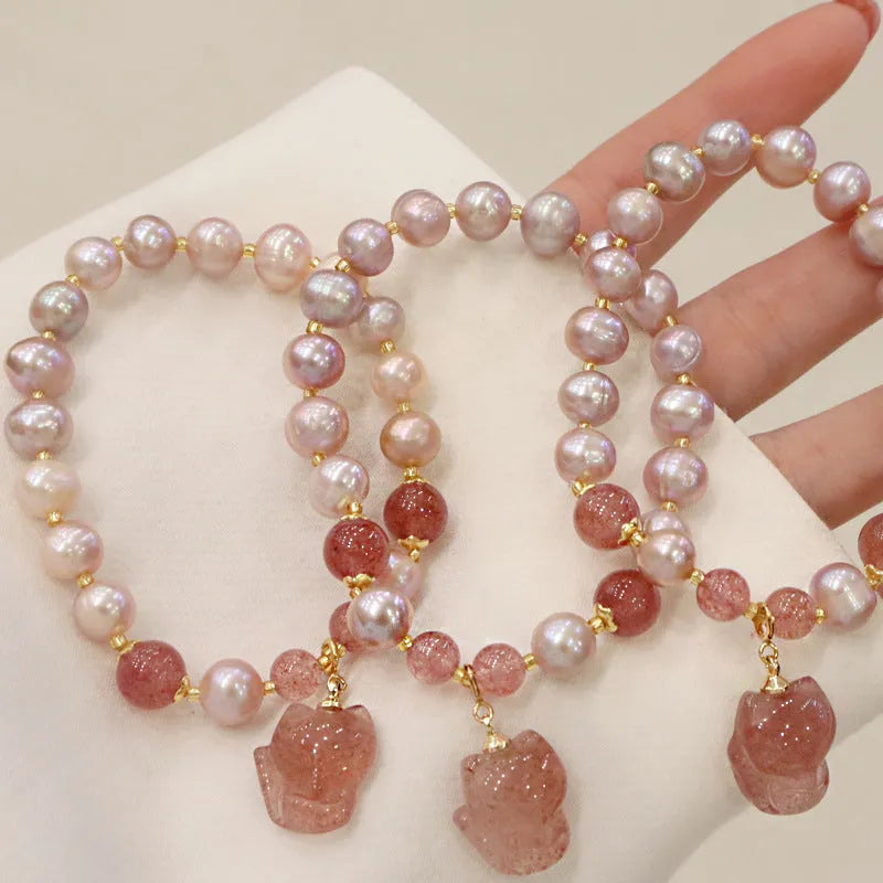 Light pink women's freshwater pearl bracelet with strawberry quartz stones and fox charm
