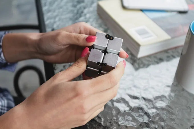 Zinc alloy infinity cube fidget toy showing black metallic finish and rotatable cube design