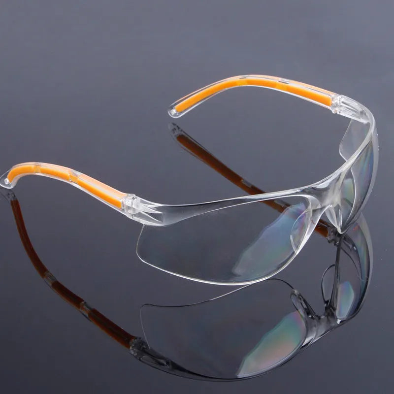 Transparent polycarbonate safety goggles with yellow lenses for eye protection.