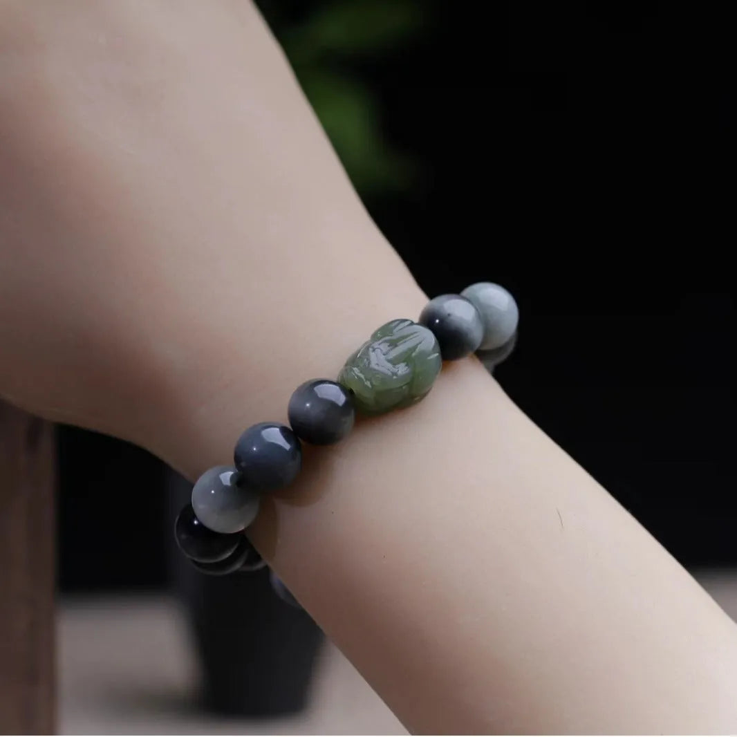 10mm Eagle Eye Stone bead bracelet with a natural Hetian Jade Clear Water Pixiu charm on a black cord.