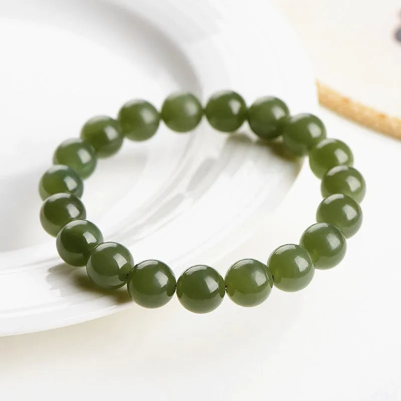 Polished Hetian jade bead bracelet in clear water colours on a wrist, showing bead size options.