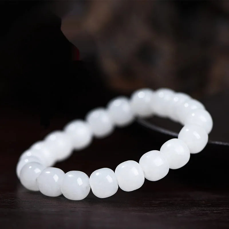 White Hetian jade barrel bead bracelet for men and women showing polished beads.