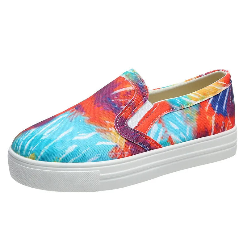 Women's blue colour match canvas trainers with flat rubber sole on a white background.