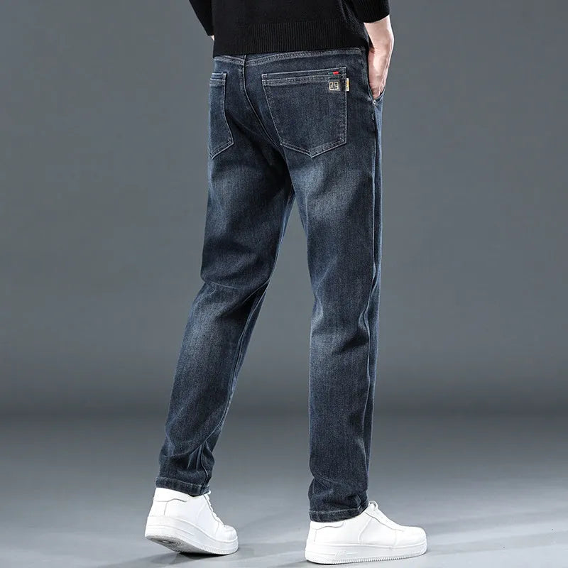 Blue grey slim straight loose casual trousers on a hanger, showing mid waist and zipper fly.
