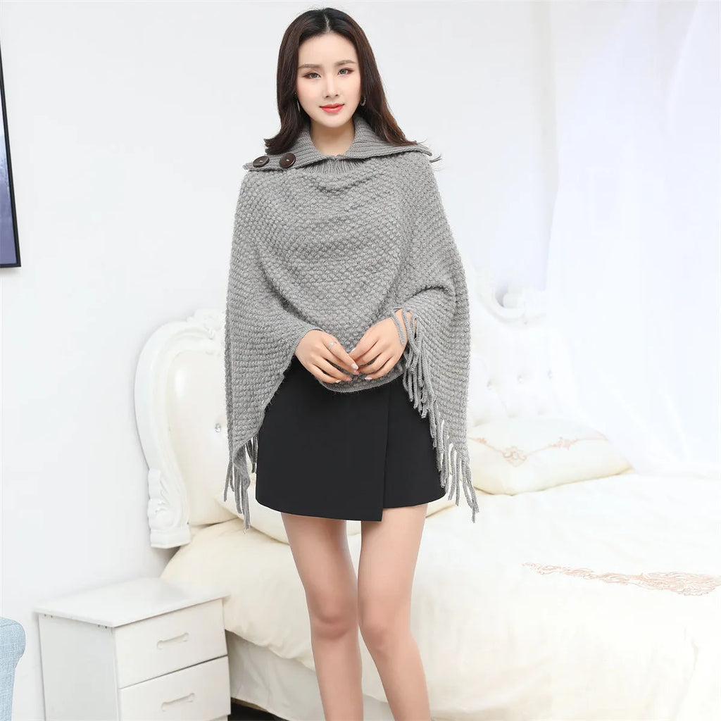 Sleeveless dotted-pattern cloak shawl in acrylic knitwear, shown in apricot colour.