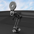 Black magnetic car phone holder mounted on car air vent with phone attached