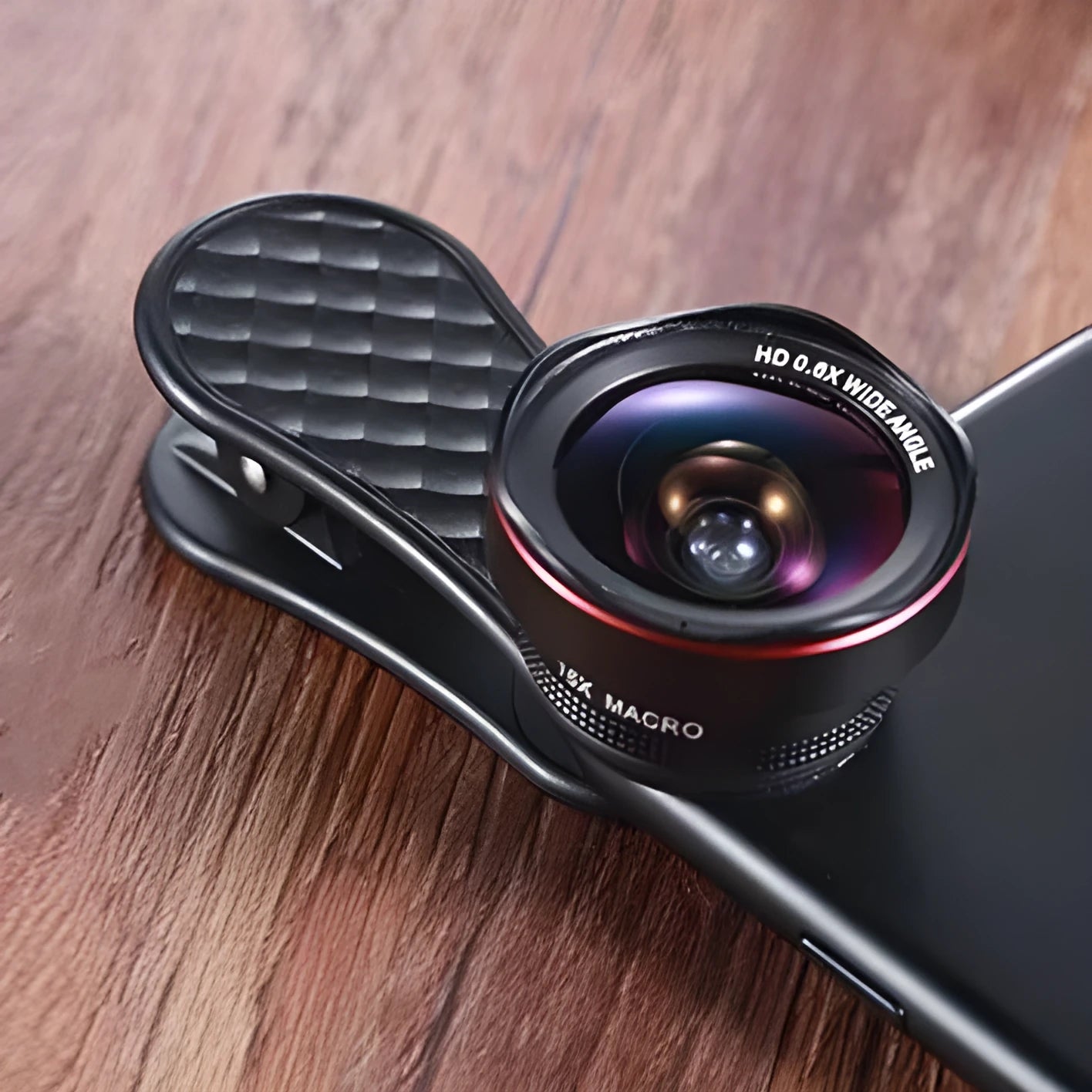 Mobile phone lens kit showing 0.6X wide-angle lens, 15X macro lens, clip attachment, storage case and cleaning cloth