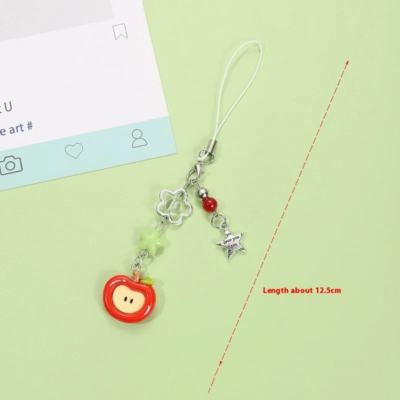 Mobile phone charm keychain with fruit designs including apple and strawberry patterns