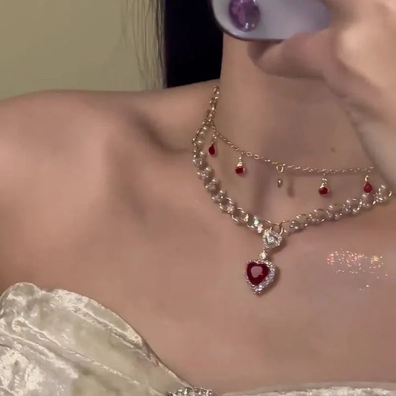 Red love heart and pearl charm on a double-layer adjustable alloy necklace.