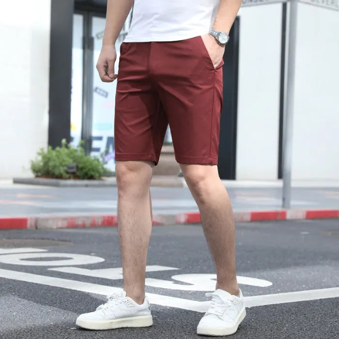 Man wearing grey elastic-waist mid-length casual shorts.