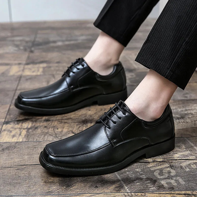 Men's black square toe business casual leather shoes with rubber sole on wooden background
