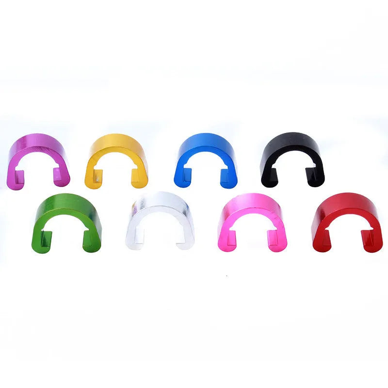 Set of ten small aluminium alloy C-shaped buckles in various colours on a white background.