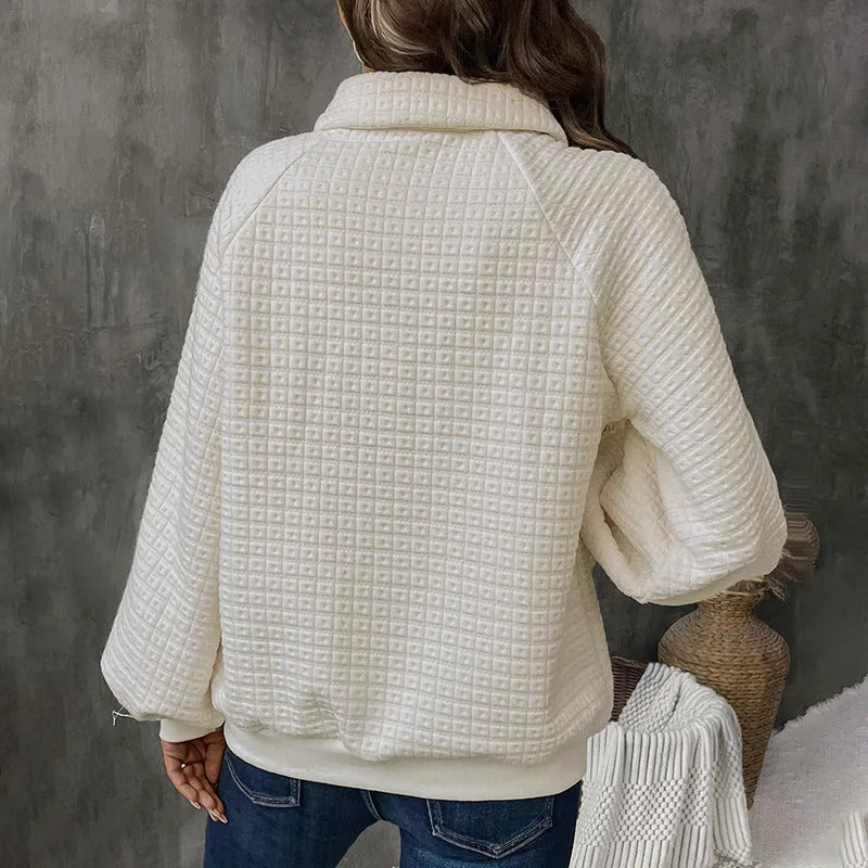 Women's milky white polo collar pullover sweater with long sleeves on a hanger.