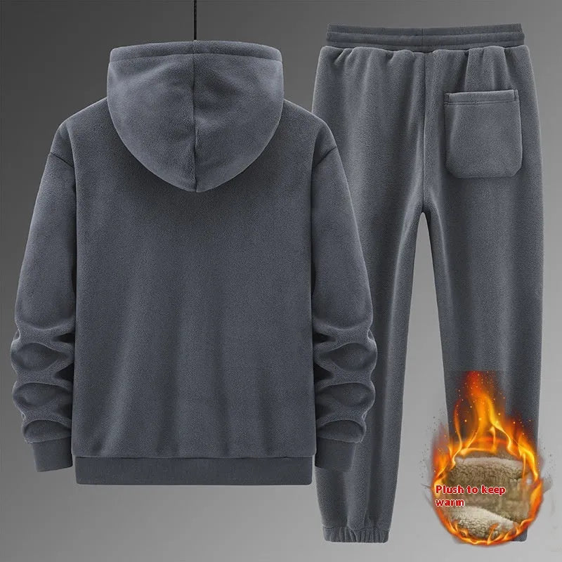 A grey men's casual sports suit featuring a hooded sweater and matching trousers on a hanger.
