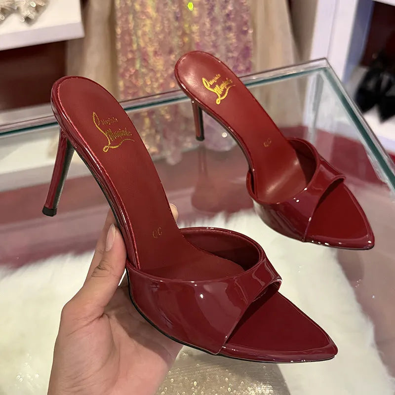 Women's black patent leather pointed toe sandals with an 8cm stiletto heel and ankle strap.